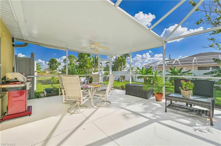 View of patio featuring a lanai and ceiling fan