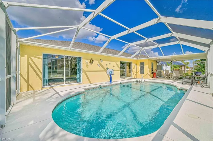 View of pool featuring a patio and screened enclosure