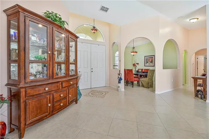 Foyer entrance with light tile floors