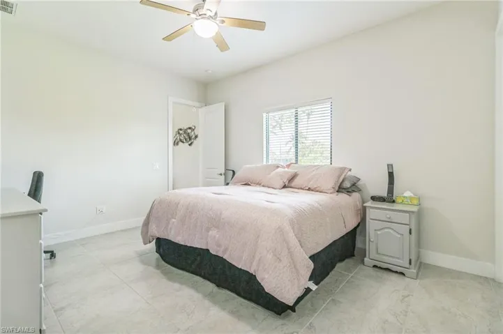 Bedroom featuring baseboards and a ceiling fan