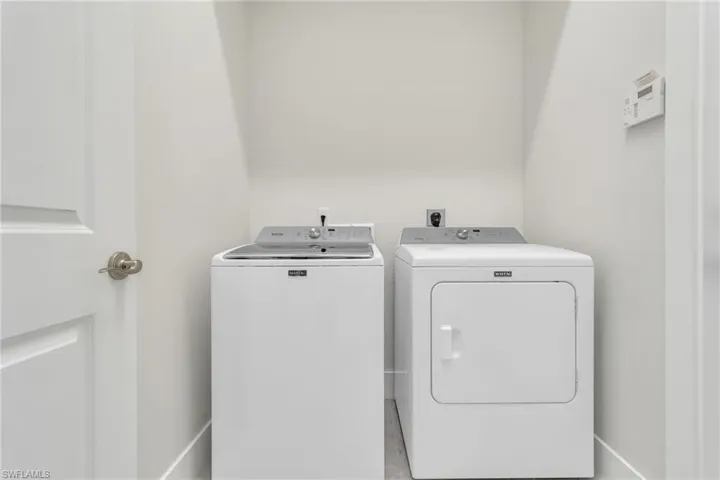 Washroom with washer and clothes dryer