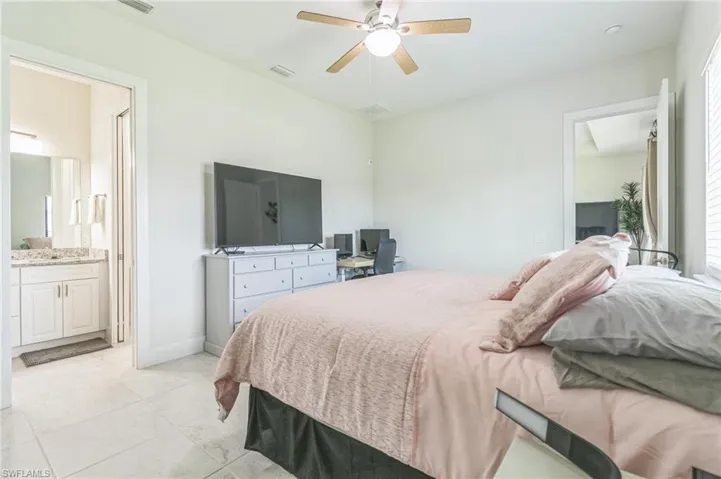 Bedroom with connected bathroom and ceiling fan
