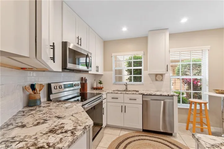 This stunning kitchen is thoughtfully designed for both functionality and style, featuring granite countertops, stainless steel appliances, custom cabinetry, and ample counter space—perfect for all your culinary needs.