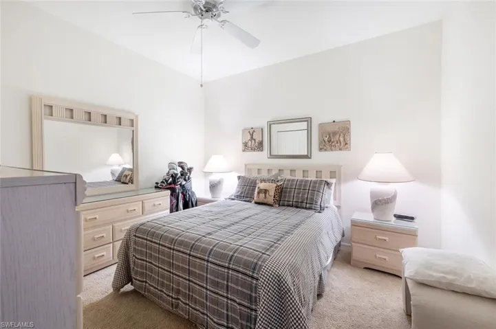 Bedroom with ceiling fan and light colored carpet