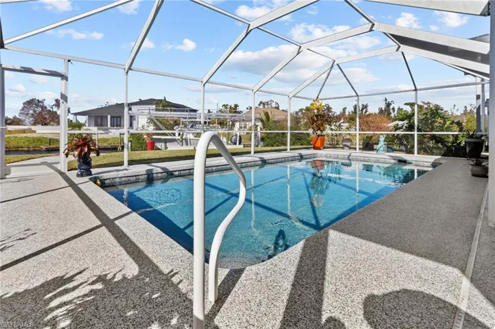 View of swimming pool with a patio and a lanai