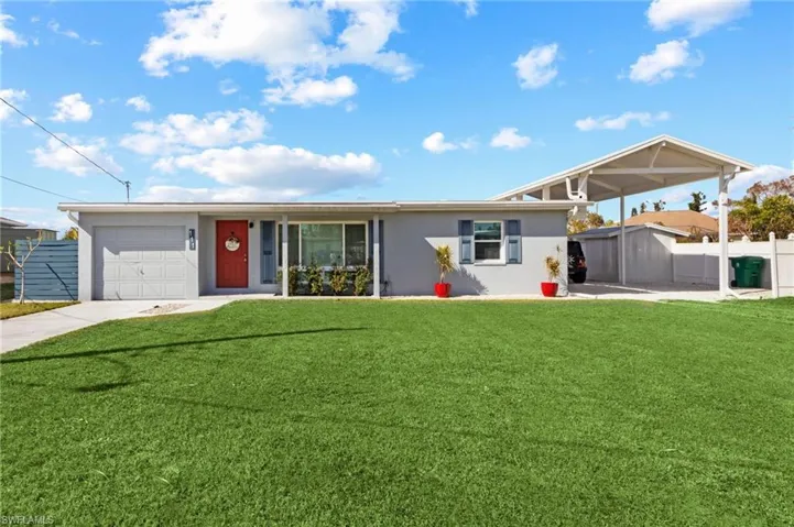Single story home featuring a front lawn and a garage
