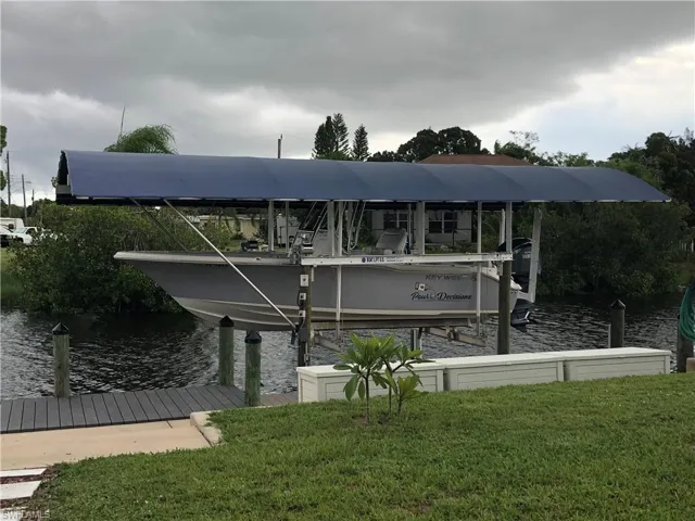 Dock area featuring a water view and a lawn
