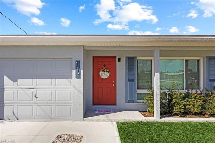 View of exterior entry with a garage