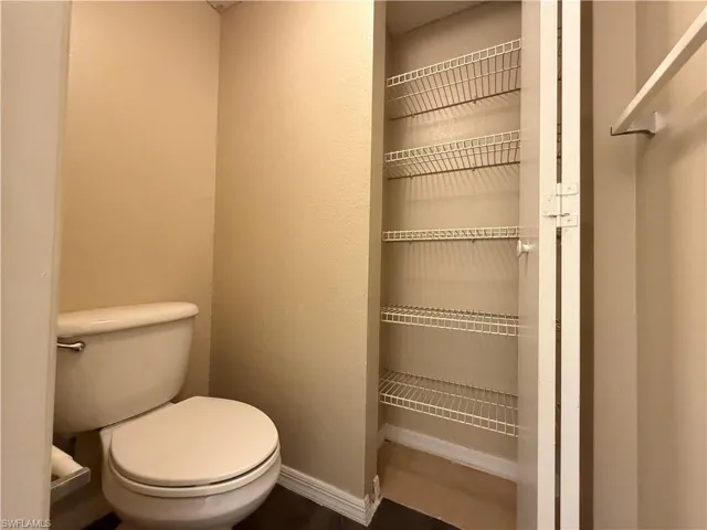 Bathroom featuring toilet and baseboards