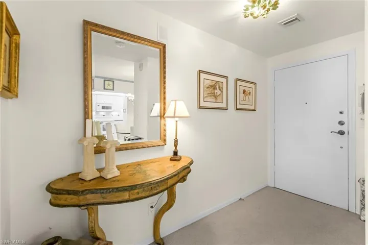 Entrance foyer with carpet flooring