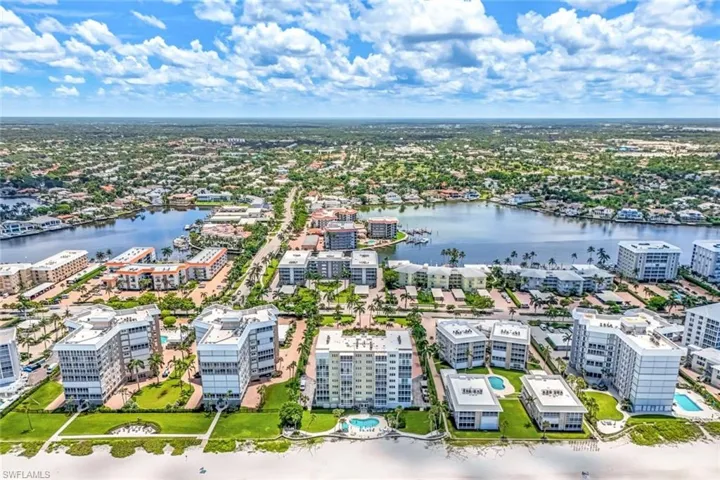 Birds eye view of property with a water view