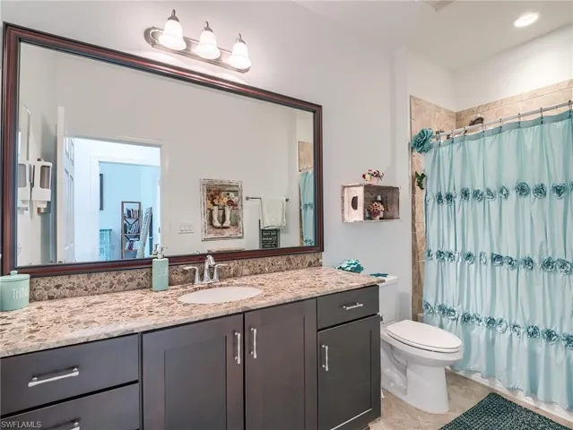 Bathroom with tile floors, toilet, and vanity