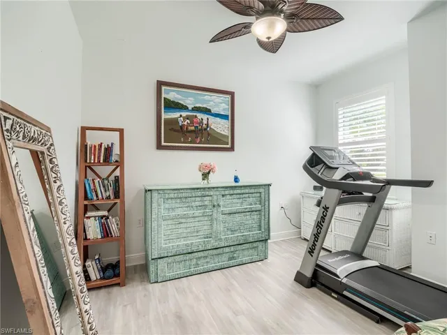 Workout room featuring ceiling fan and hardwood / wood-style flooring