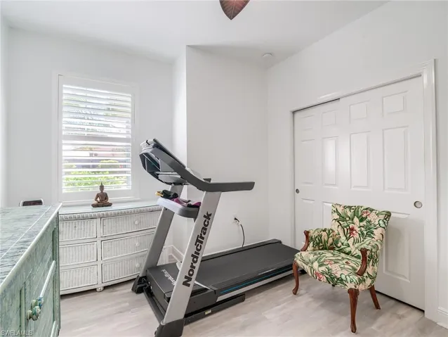 Exercise area featuring light wood-type flooring