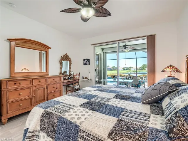 Bedroom with ceiling fan, light hardwood / wood-style floors, and access to exterior