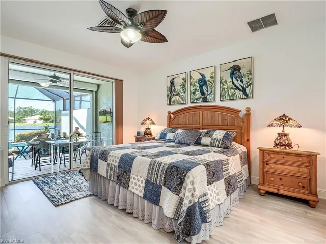 Bedroom with ceiling fan, light hardwood / wood-style flooring, and access to exterior