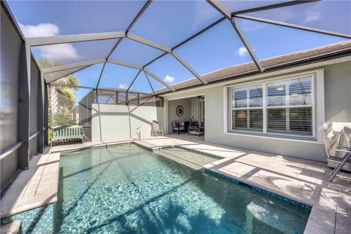 View of pool with a patio and a lanai