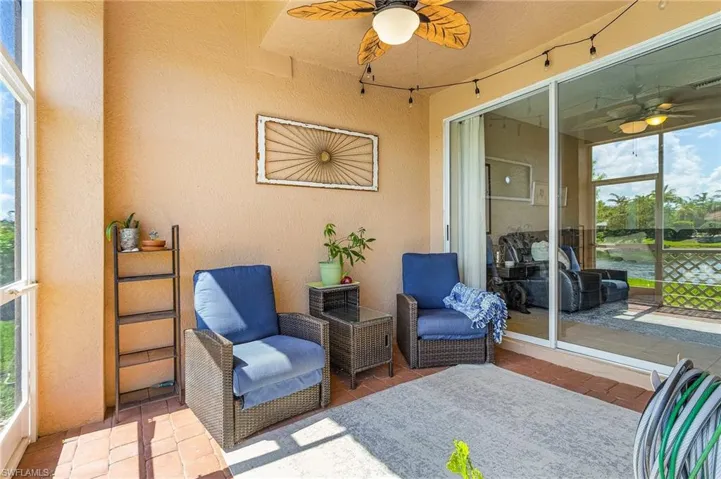 Sunroom with ceiling fan, two reclining chairs and side table