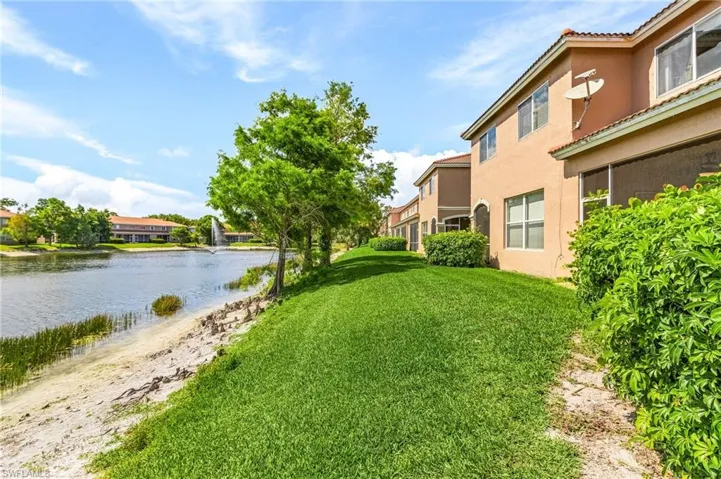 View of green lawn with a water view/ water feature