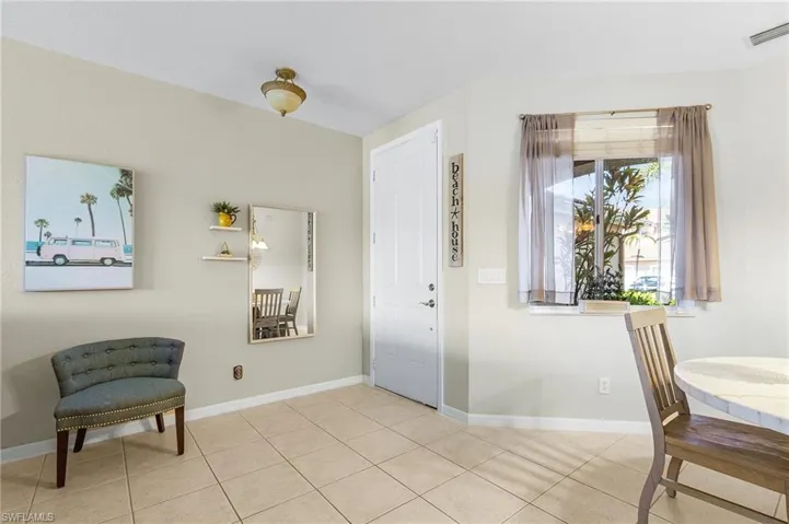 Tiled entrance foyer with baseboards