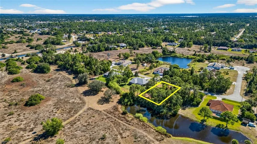 Aerial view of property's location with property parcel outlined and a nearby body of water
