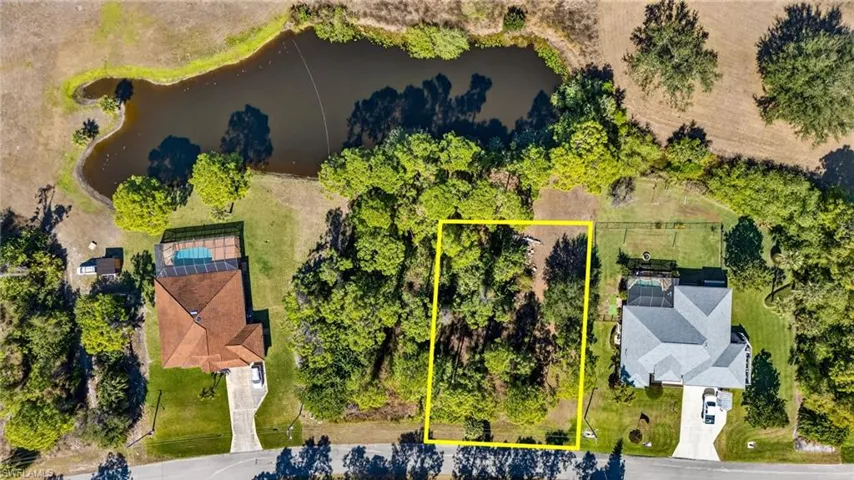 Aerial overview of property's location with a large body of water and property boundaries highlighted