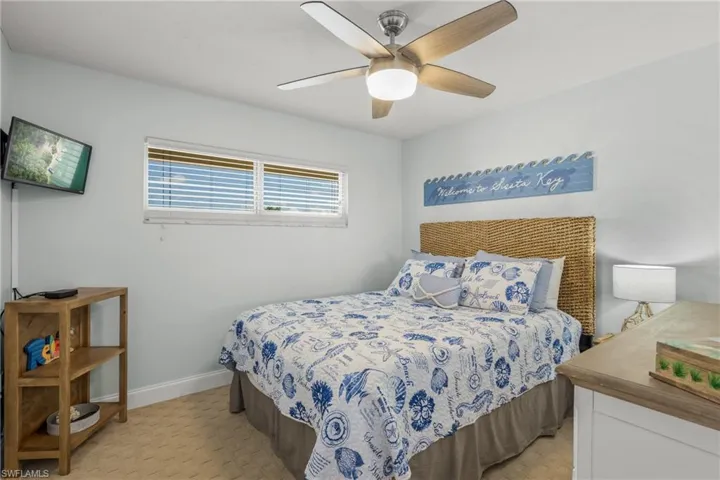 Bedroom with a ceiling fan and baseboards