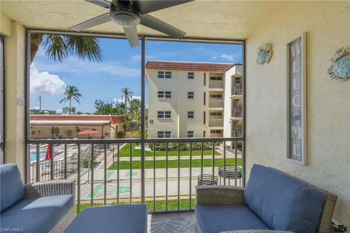 Balcony featuring a ceiling fan and a sunroom