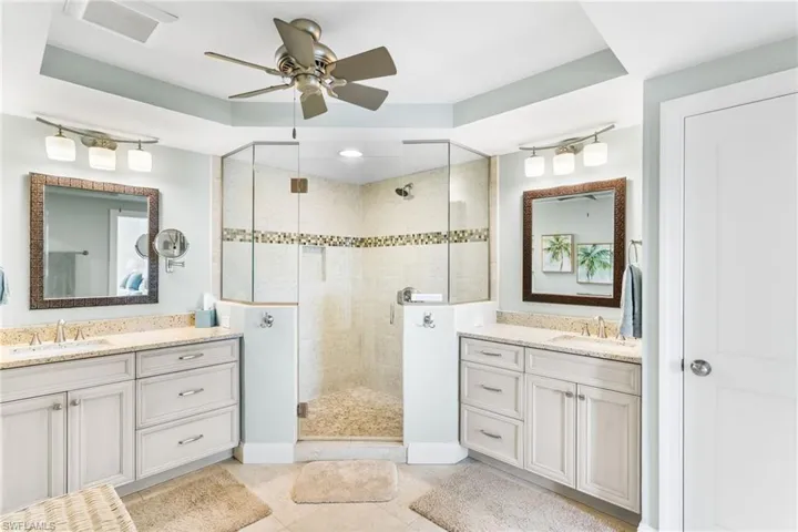Two separate vanities, quartz counters, custom shower tile, pebble shower floor, newer lighting/plumbing fixtures