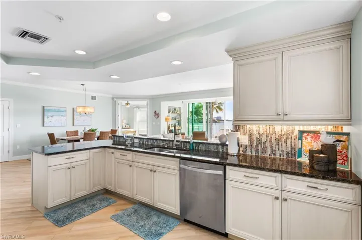 Beautiful white wood, soft close cabinetry, under cabinetry lighting, custom tiled backsplash.