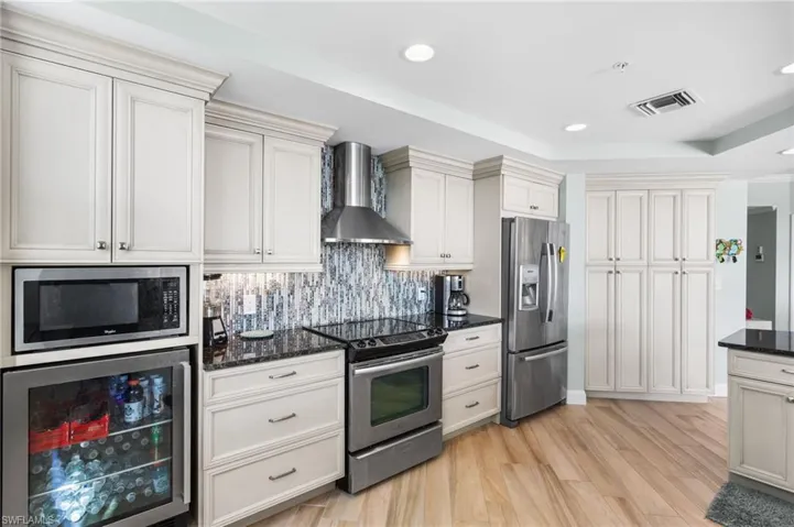 Additional beverage fridge, built in microwave, stainless appliances and oven hood.