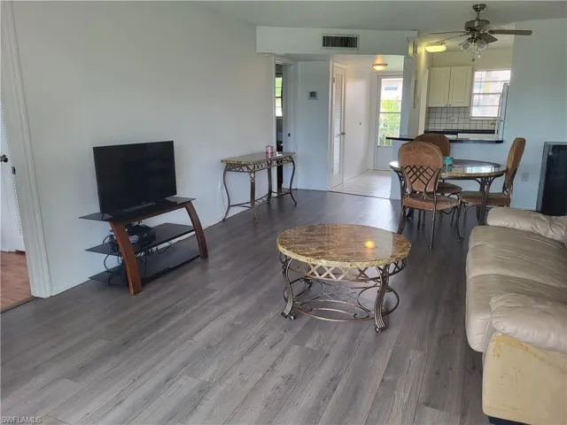 Living room featuring hardwood / wood-style flooring and ceiling fan