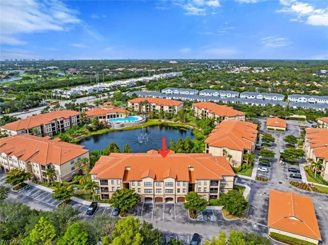 Drone / aerial view of a large body of water and apartment complex / building