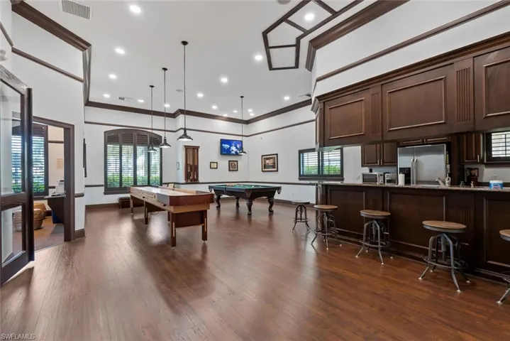 Rec room featuring pool table, crown molding, recessed lighting, and a towering ceiling