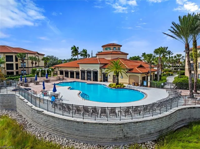 Community pool with a patio