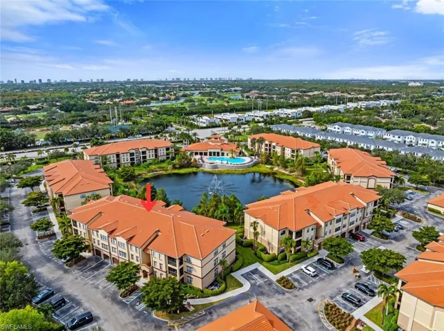Aerial view of apartment complex and a nearby body of water