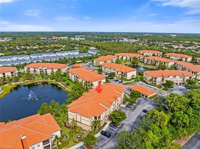 Aerial view of apartment complex / building and a nearby body of water