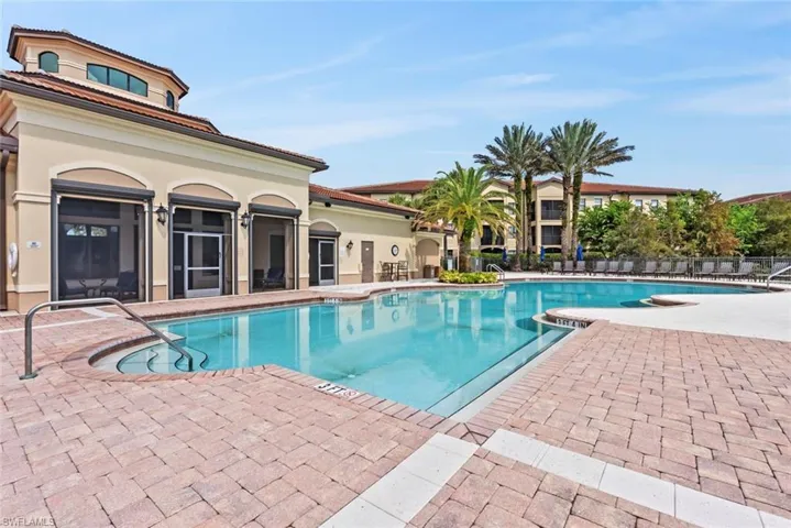Community pool with a patio