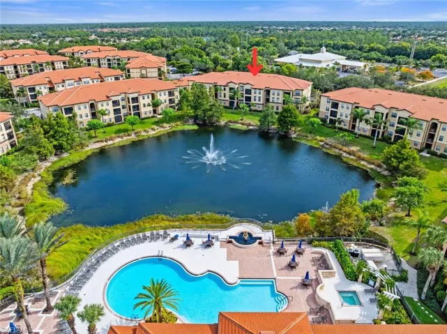 Drone / aerial view of a pool and a large body of water