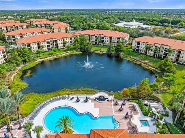 Drone / aerial view of a large body of water and a pool