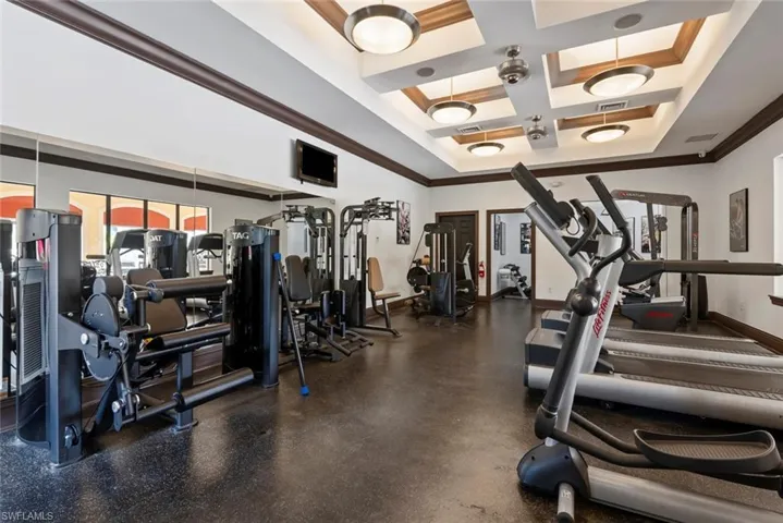 Gym with coffered ceiling, beamed ceiling, and crown molding