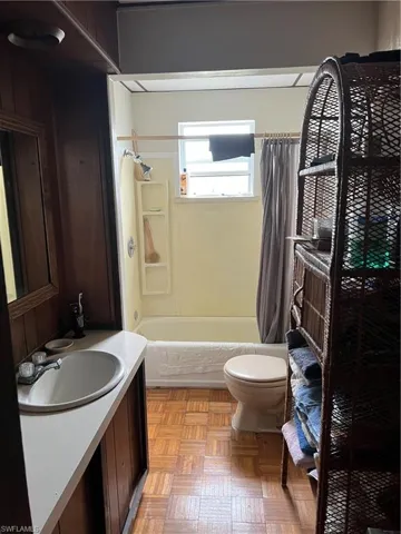 Bathroom with vanity and shower / bath combo with shower curtain
