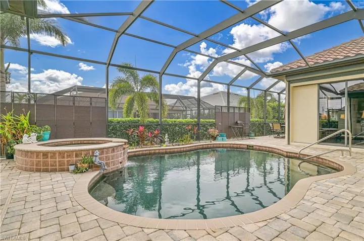 View of pool featuring an in ground hot tub, a patio, and a lanai