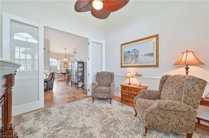 Living area with ceiling fan with notable chandelier