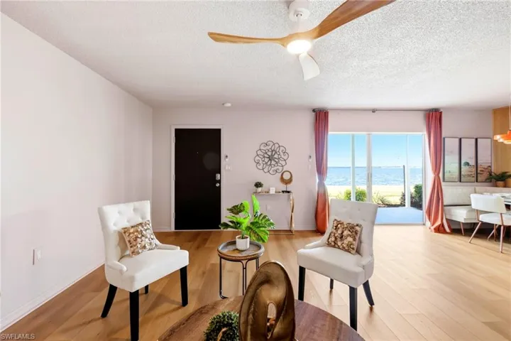 Living area with ceiling fan and vinyl flooring