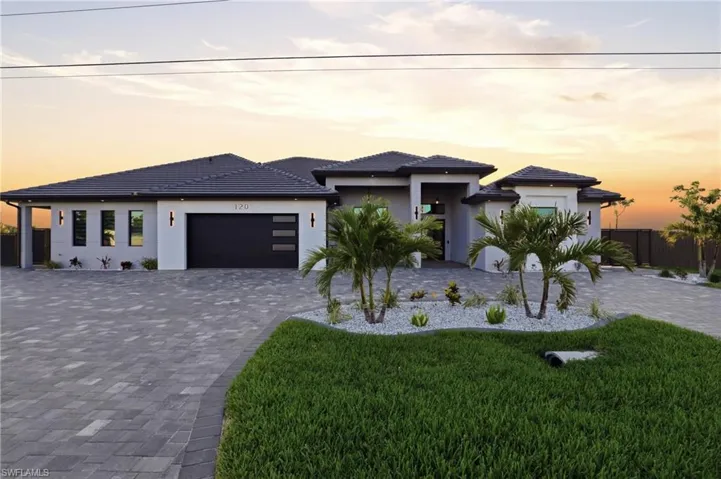 Contemporary single-story residence with a multi-gabled roofline and a paver driveway