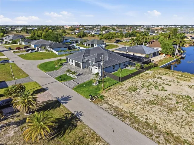 Expansive canal-front property featuring a cleared lot, street-side access, and ample space for development