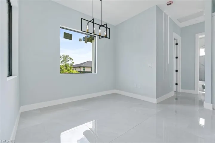 Dining space featuring tile patterned flooring and a notable chandelier