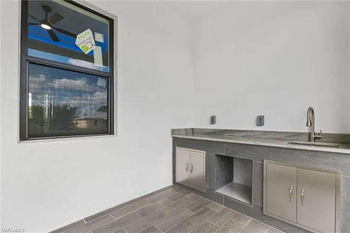 Washroom with sink, ceiling fan, and hardwood / wood-style floors