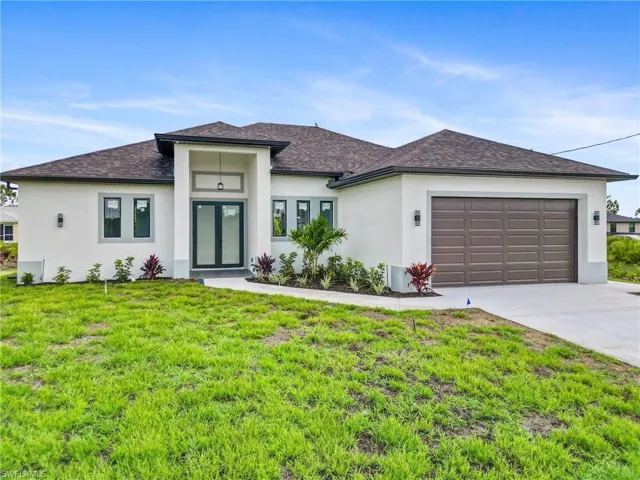 Prairie-style house with a garage and a front lawn